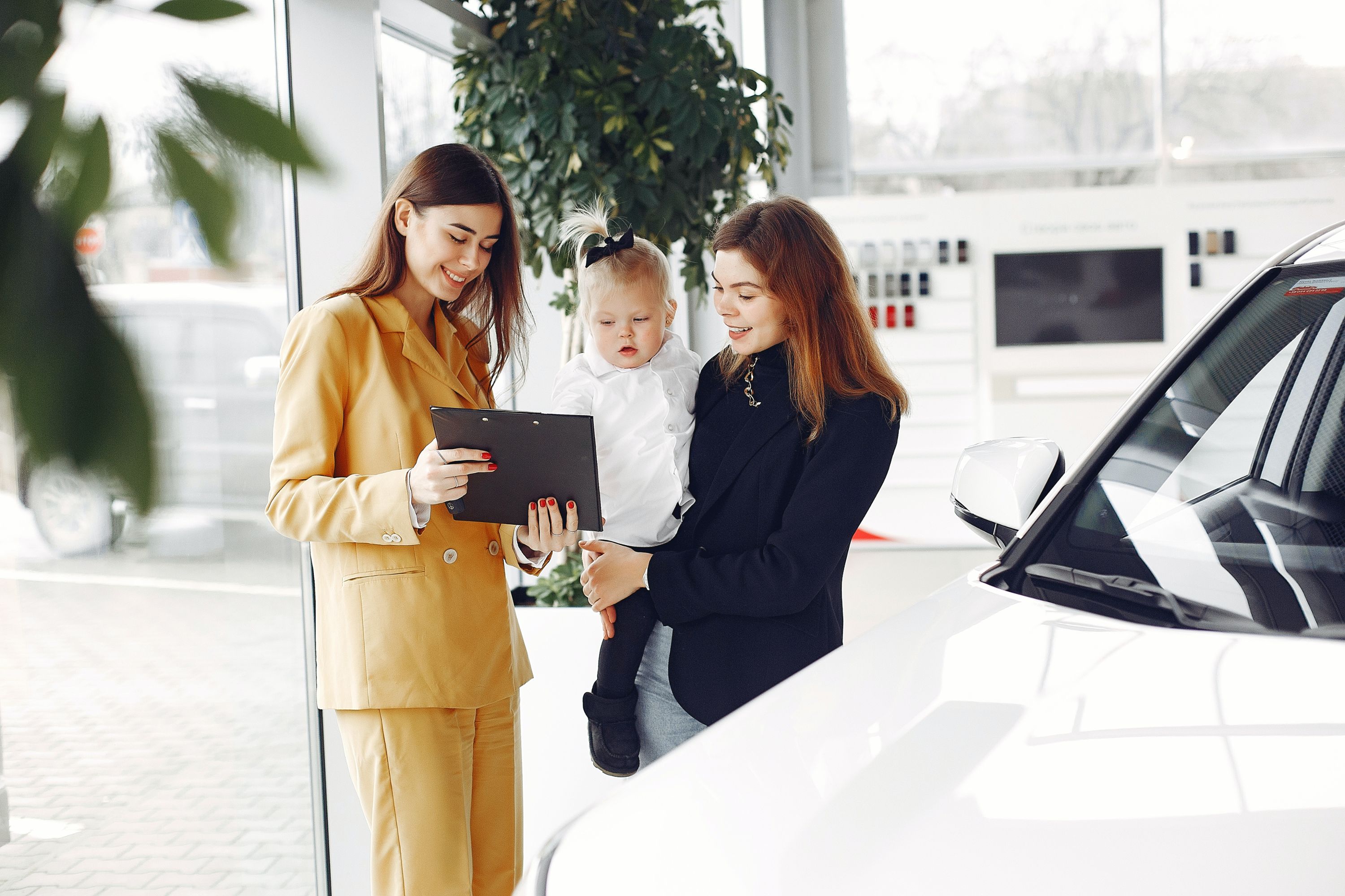 Woman and baby at car dealership